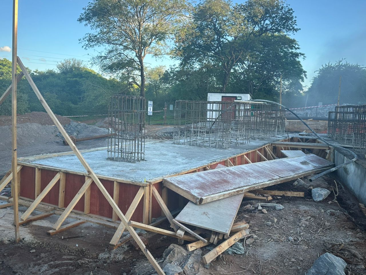 Formwork being stripped from freshly poured concrete plinths 