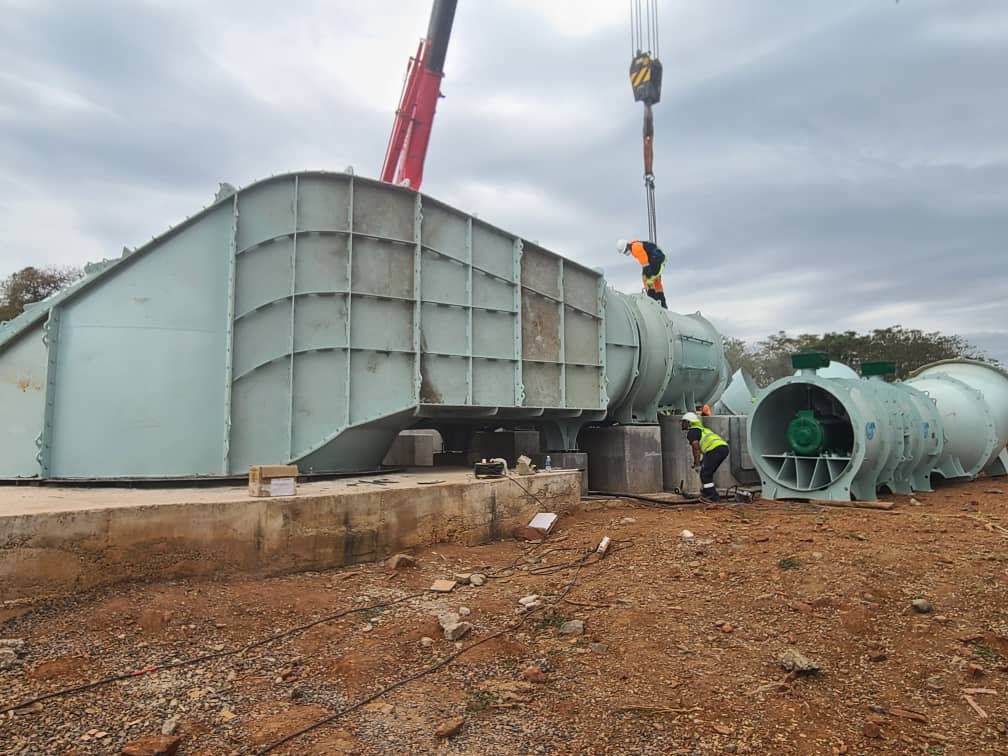 Large inlet box being lowered onto foundation by crane